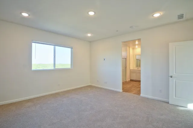 an empty room with windows and closet