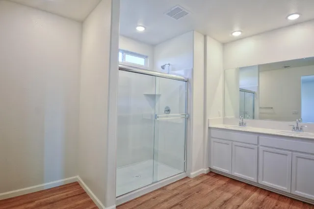 a bathroom with a shower and a sink