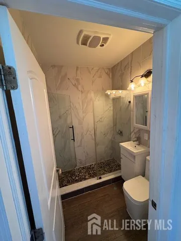 a bathroom with a toilet and a shower
