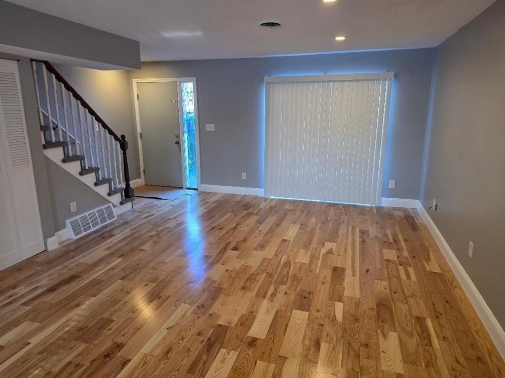 24 Harvard Road, Unit C Ayer, MA 01432 - Photo 3 of 20 a view of empty room with wooden floor