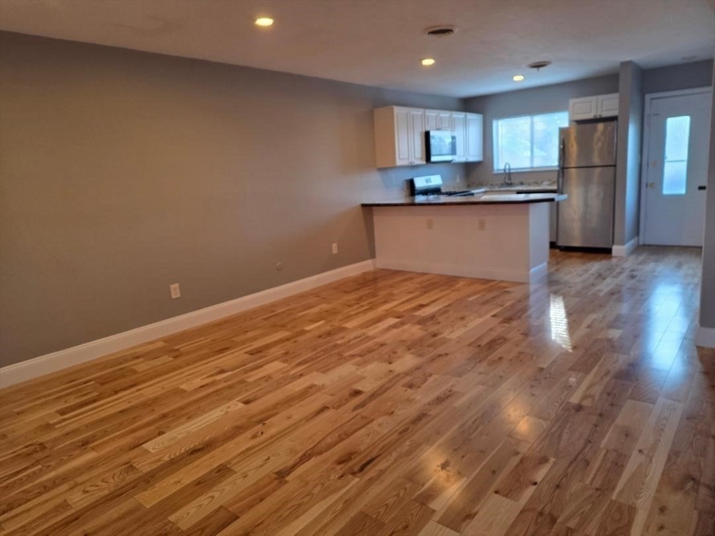 24 Harvard Road, Unit C Ayer, MA 01432 - Photo 5 of 20 a kitchen with granite countertop a sink and cabinets