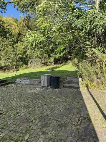 a view of house with a yard