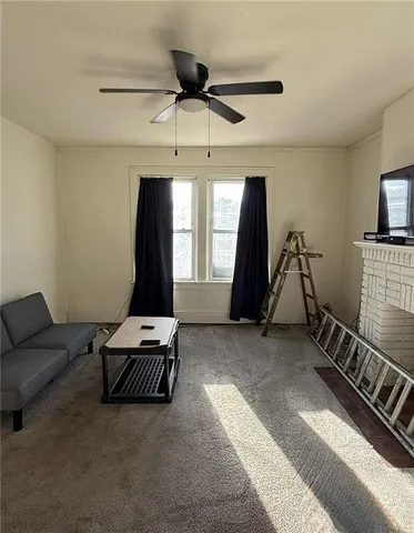 a living room with furniture a flat screen tv and white walls