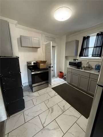 a kitchen with granite countertop a stove and a refrigerator