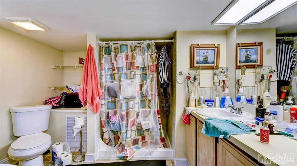 919 Hermann Road North Brunswick, NJ 08902 - Photo 6 of 13 a bathroom with a toilet sink and shower curtain
