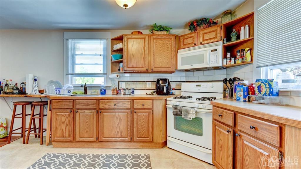 919 Hermann Road North Brunswick, NJ 08902 - Photo 7 of 13 a kitchen with stainless steel appliances granite countertop a stove a sink and a refrigerator