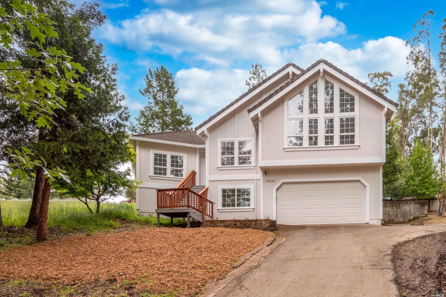 11165 Cherry Ridge Road Sebastopol, CA 95472 - Photo 1 of 1 a front view of a house with a yard and garage