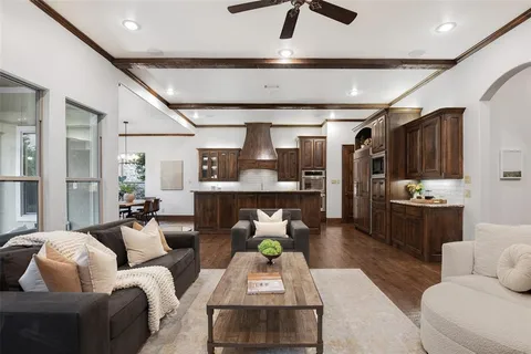a living room with furniture and kitchen view