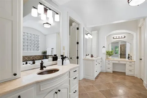 a spacious bathroom with a granite countertop sink mirror and bathtub