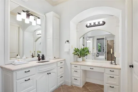 a spacious bathroom with a sink and a mirror