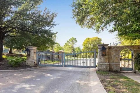 a view of entrance gate of trees and buildings
