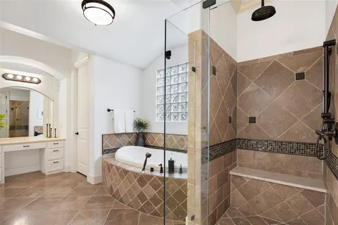 a bathroom with a tub a sink and a shower