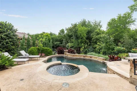 a view of swimming pool with a chair and tables