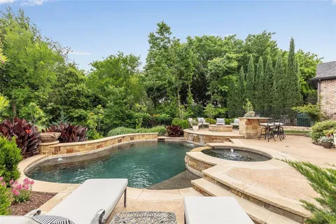 a view of a swimming pool with a yard