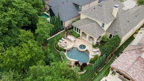an aerial view of a house with table and chairs