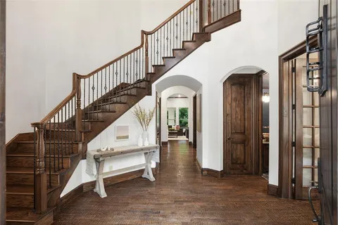 a view of entryway and hall with wooden floor