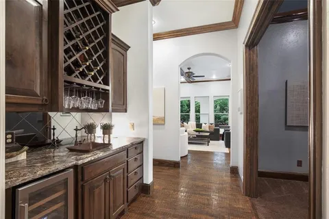 a kitchen with a sink and a large mirror