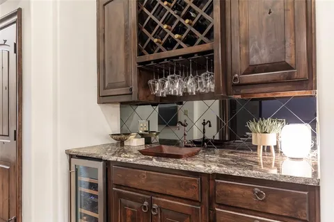 a kitchen with granite countertop a stove and cabinets