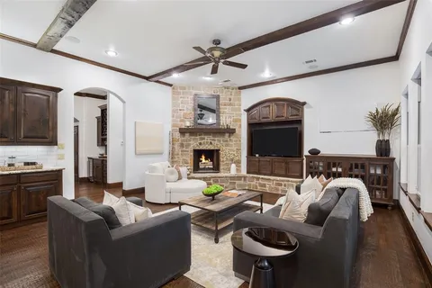 a living room with furniture a fireplace and a flat screen tv