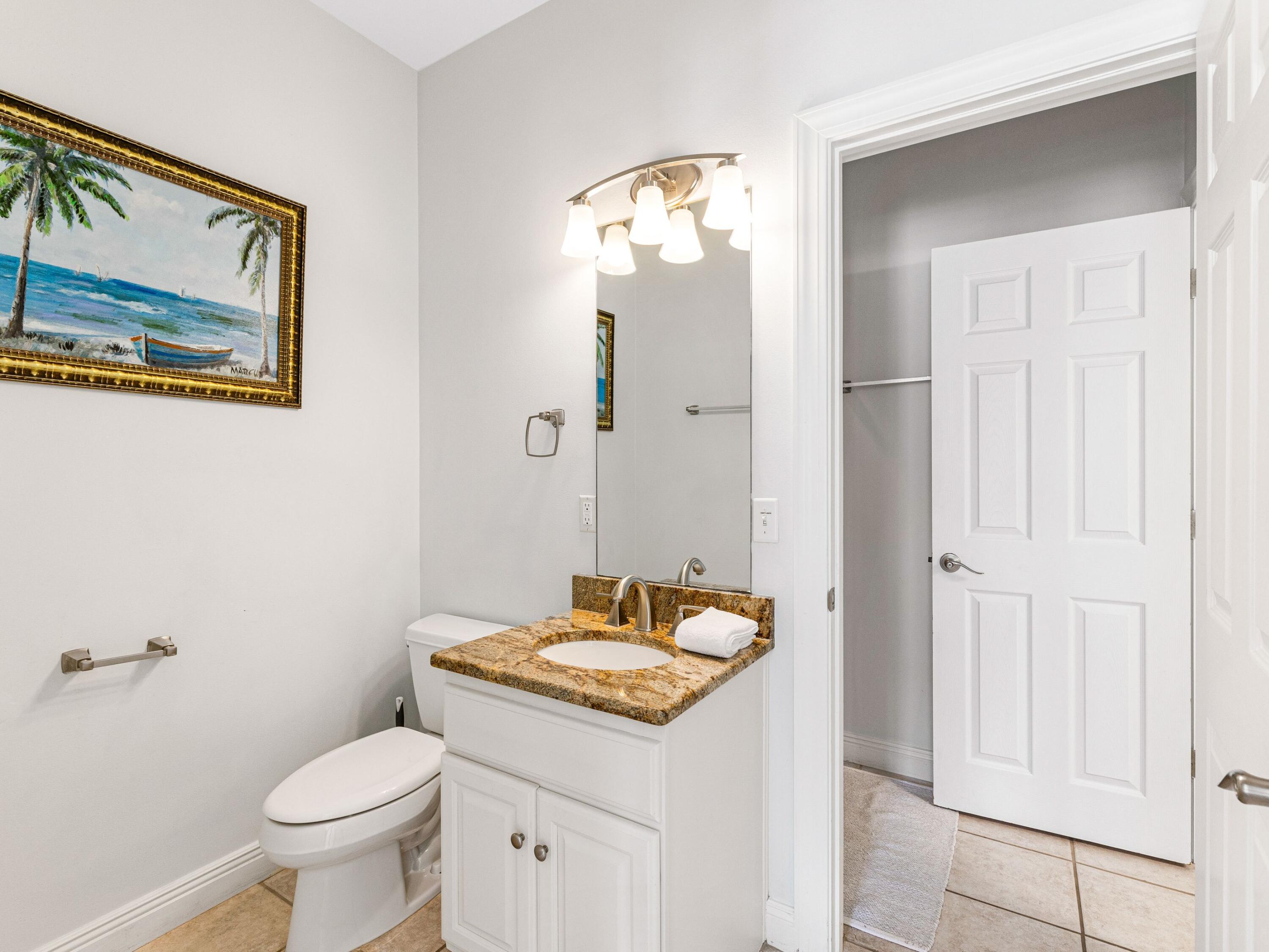 41 Winston Lane Inlet Beach, FL 32461 - Photo 44 of 50 a bathroom with a granite countertop sink a toilet and a mirror