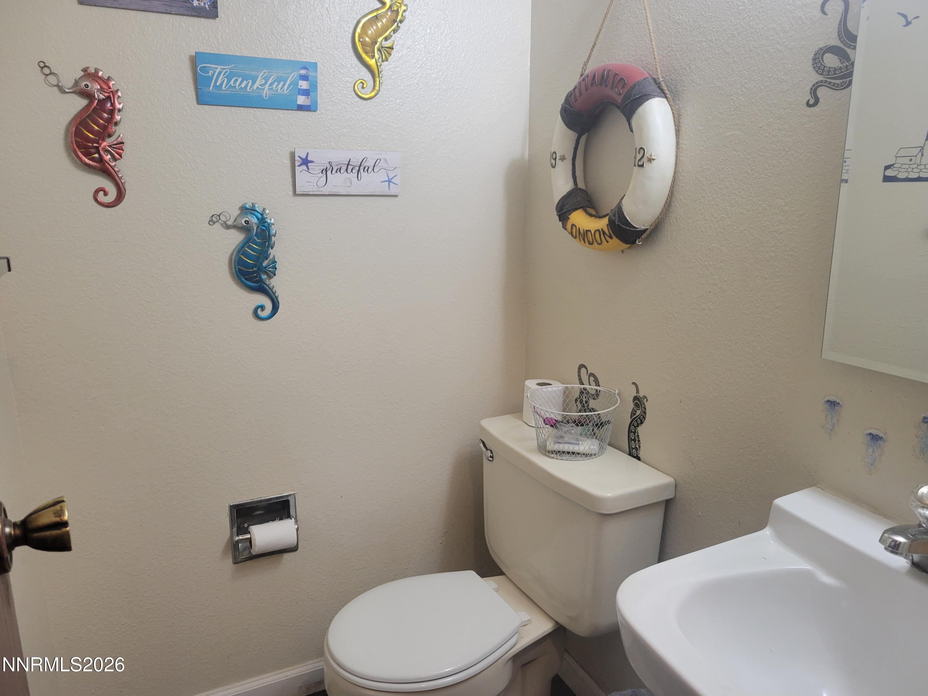 1404 East 9th Street, Unit 3 Reno, NV 89512 - Photo 14 of 29 a bathroom with a toilet sink and mirror