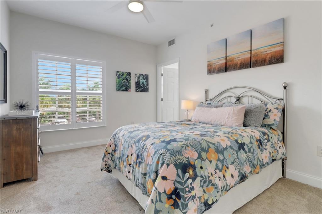 4430 Botanical Pl Circle, Unit 101 Naples, FL 34112 - Photo 11 of 18 a bedroom with a bed and a window