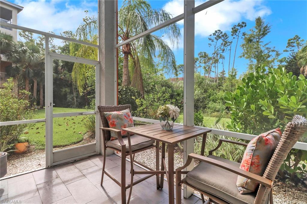 4430 Botanical Pl Circle, Unit 101 Naples, FL 34112 - Photo 13 of 18 a view of a chairs and table in the patio