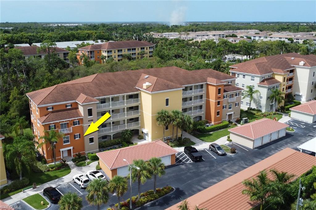 4430 Botanical Pl Circle, Unit 101 Naples, FL 34112 - Photo 18 of 18 an aerial view of a houses with a swimming pool