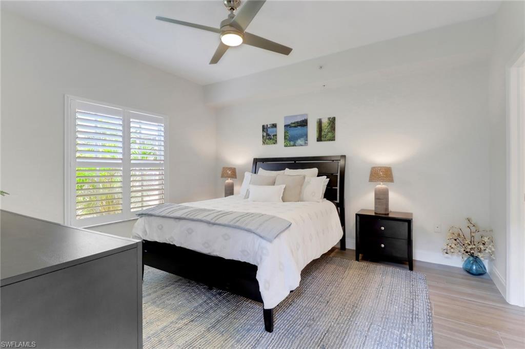 4430 Botanical Pl Circle, Unit 101 Naples, FL 34112 - Photo 6 of 18 a bedroom with a bed and a window