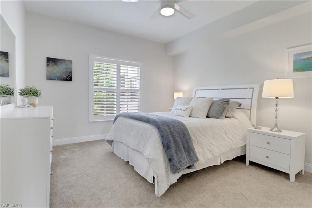 4430 Botanical Pl Circle, Unit 101 Naples, FL 34112 - Photo 9 of 18 a bedroom with a bed and a window