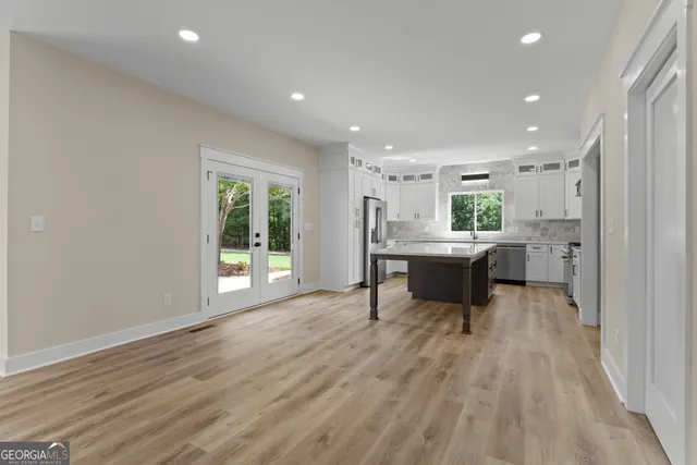 a kitchen with a table chairs sink and cabinets