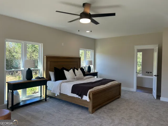 a view of a sink and an empty room with wooden floor