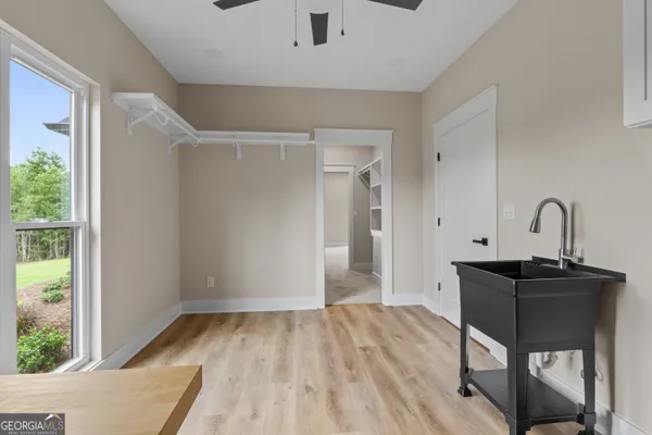 an empty room with a ceiling fan and a ceiling fan