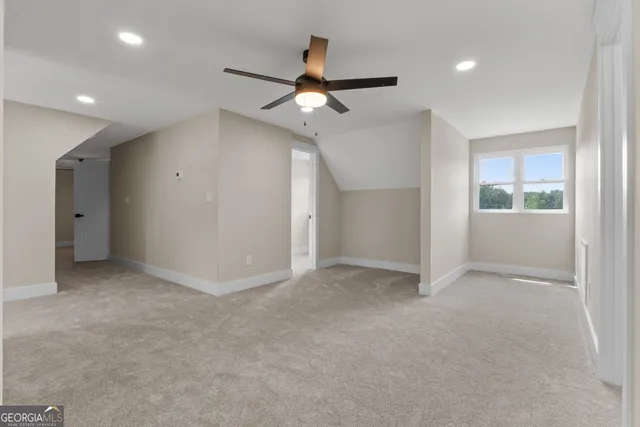 a view of a white house with a big yard and large trees