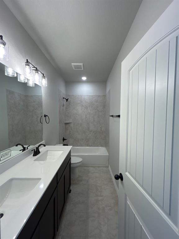 8779 County Road 623 Blue Ridge, TX 75424 - Photo 11 of 14 Bathroom featuring a dual vanity with white countertops, dark cabinetry, and dual undermount sinks