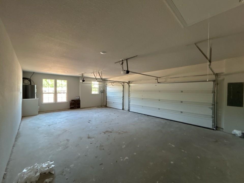 8779 County Road 623 Blue Ridge, TX 75424 - Photo 12 of 14 Spacious garage featuring two overhead doors with automatic openers, concrete flooring, and multiple windows providing natural light
