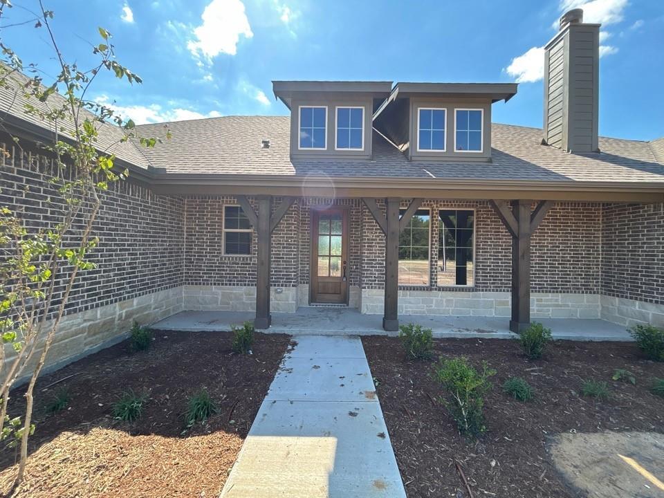 8779 County Road 623 Blue Ridge, TX 75424 - Photo 3 of 14 Brick and stone facade featuring a covered front porch with exposed timber posts