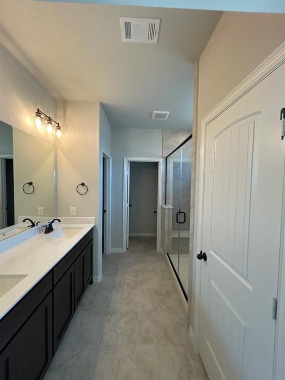 8779 County Road 623 Blue Ridge, TX 75424 - Photo 8 of 14 Bathroom featuring an extended double vanity with dark cabinetry, white countertops, and dual rectangular undermount sinks