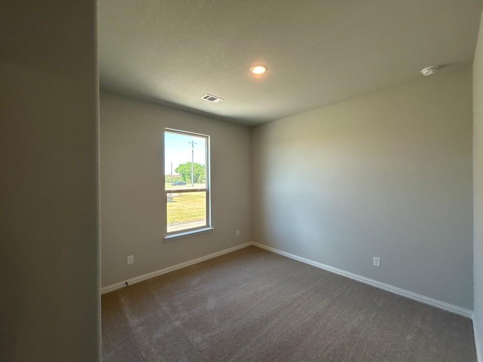 8779 County Road 623 Blue Ridge, TX 75424 - Photo 10 of 14 Interior room featuring a single window with a white frame, carpet flooring, and light-toned walls