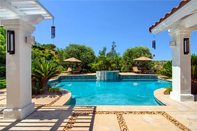 a view of a swimming pool with chairs
