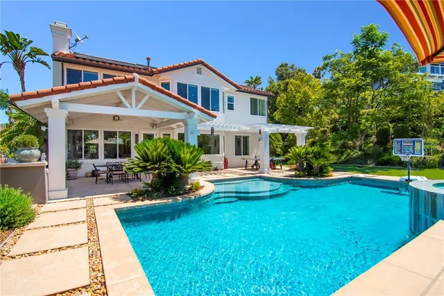 a view of a house with swimming pool and sitting area
