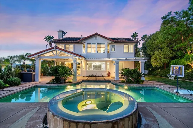a view of a house with swimming pool and sitting area