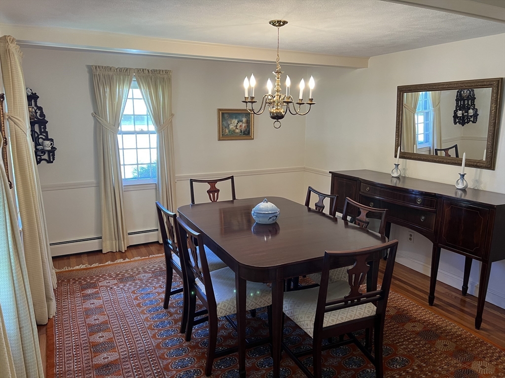 71 Greenbrook Road Hamilton, MA 01982 - Photo 11 of 33 a view of a dining room with furniture a chandelier and wooden floor