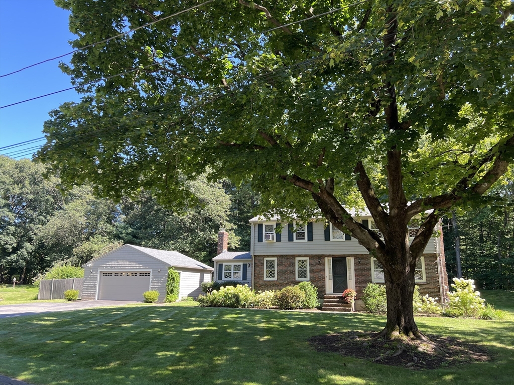 71 Greenbrook Road Hamilton, MA 01982 - Photo 2 of 33 a front view of a house with a garden and tree