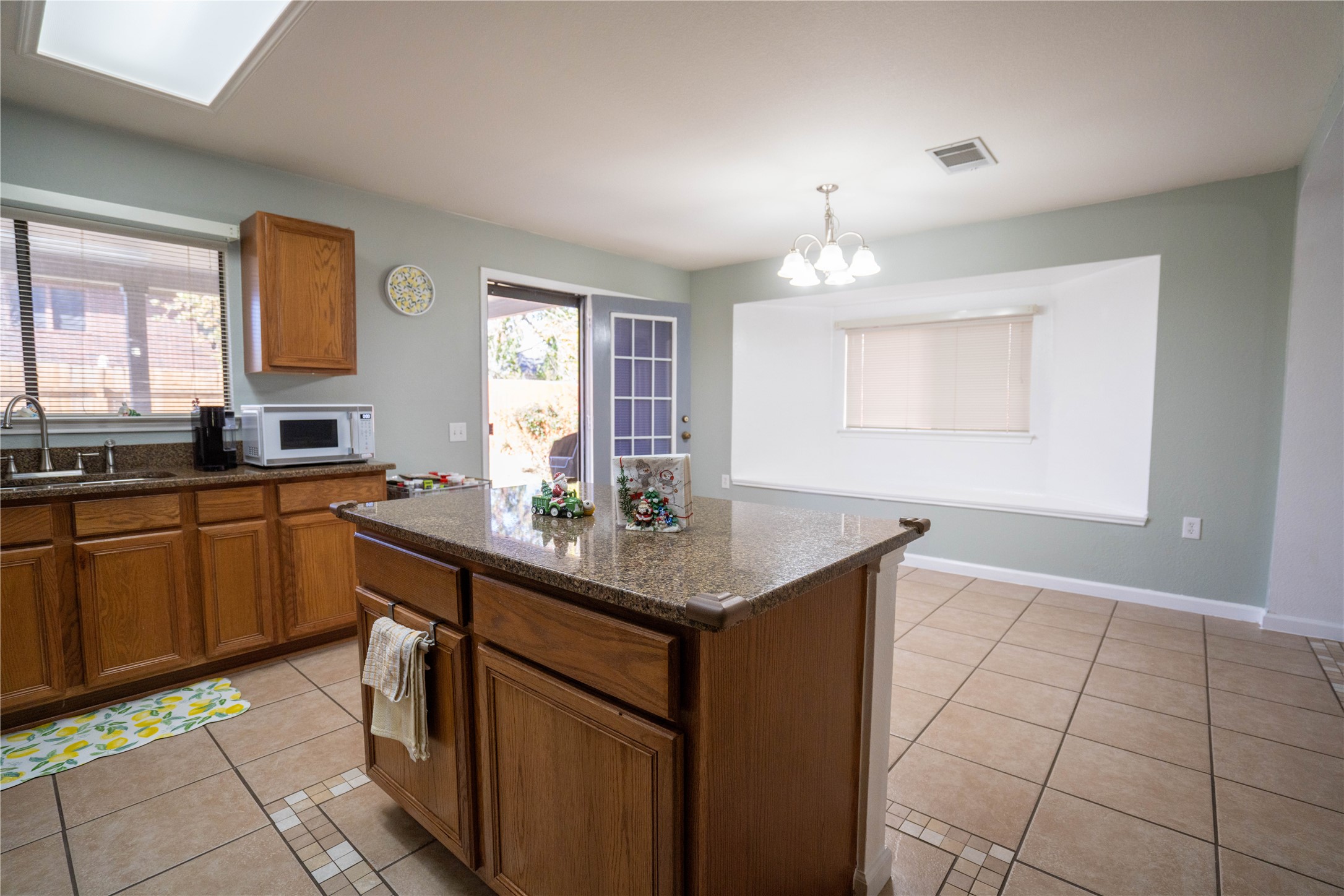7516 Cats-Eye Lane Austin, TX 78747 - Photo 12 of 30 a kitchen with a sink window and cabinets