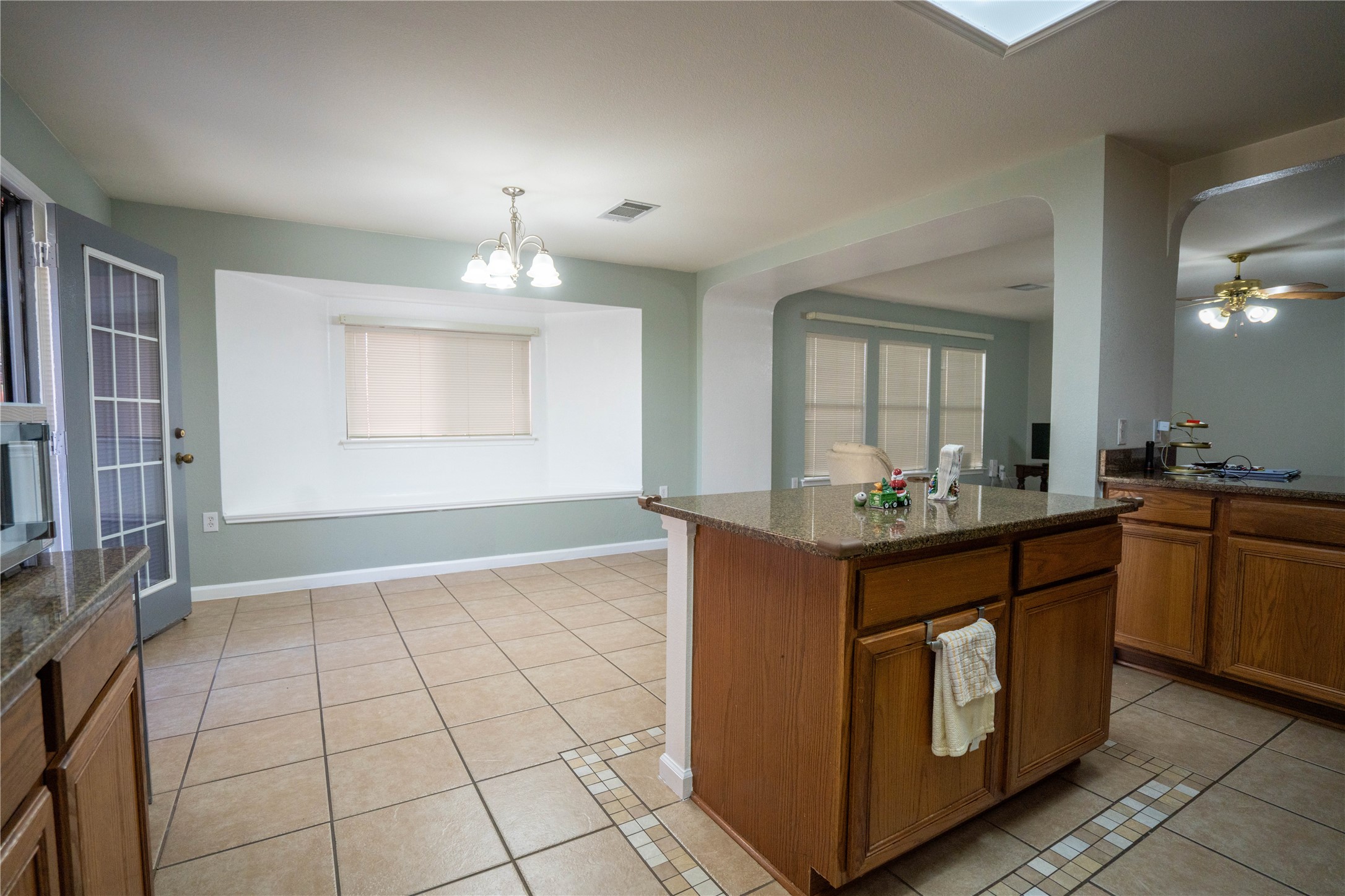 7516 Cats-Eye Lane Austin, TX 78747 - Photo 13 of 30 a kitchen with granite countertop a stove a sink and a refrigerator