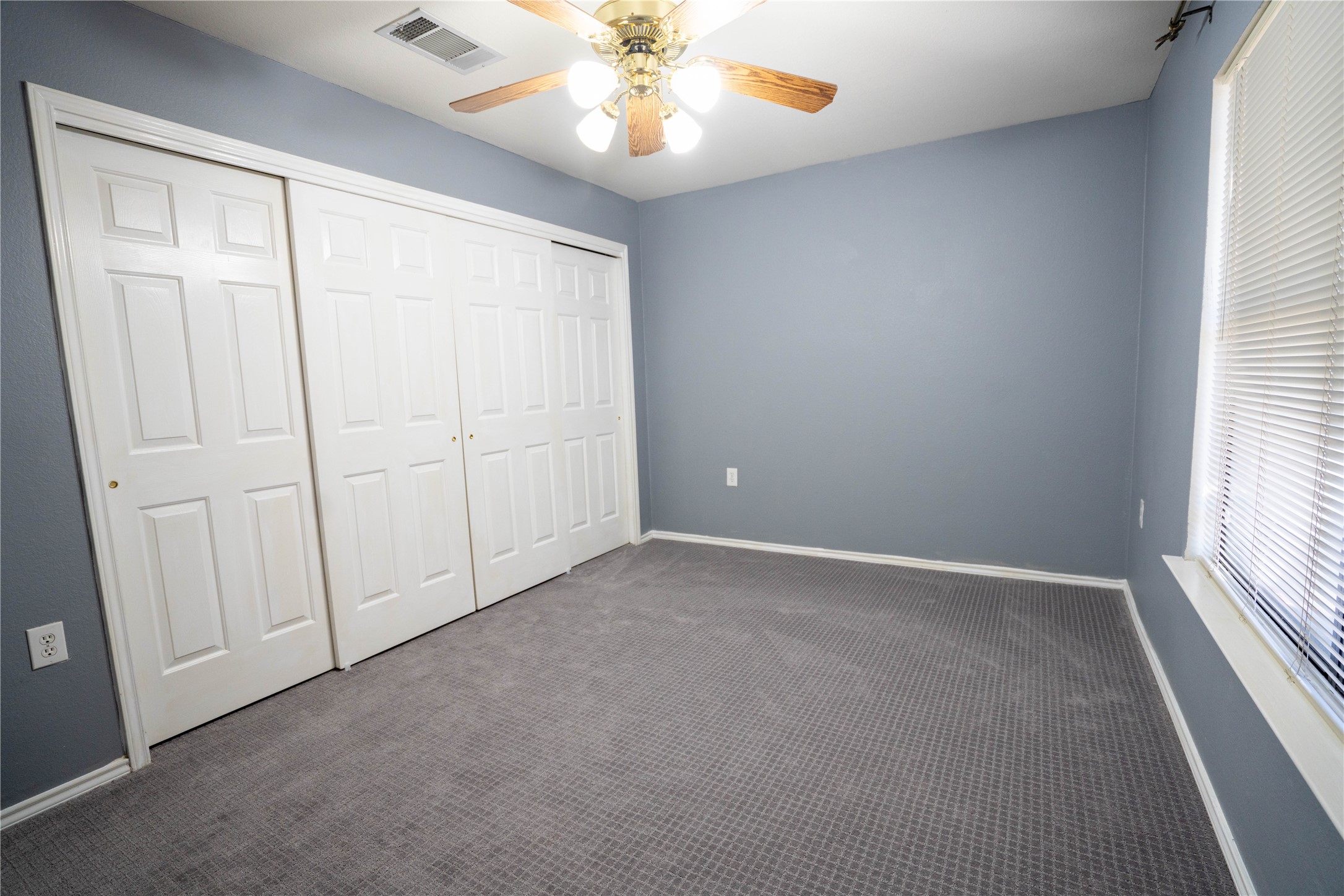 7516 Cats-Eye Lane Austin, TX 78747 - Photo 15 of 30 an empty room with windows and fan