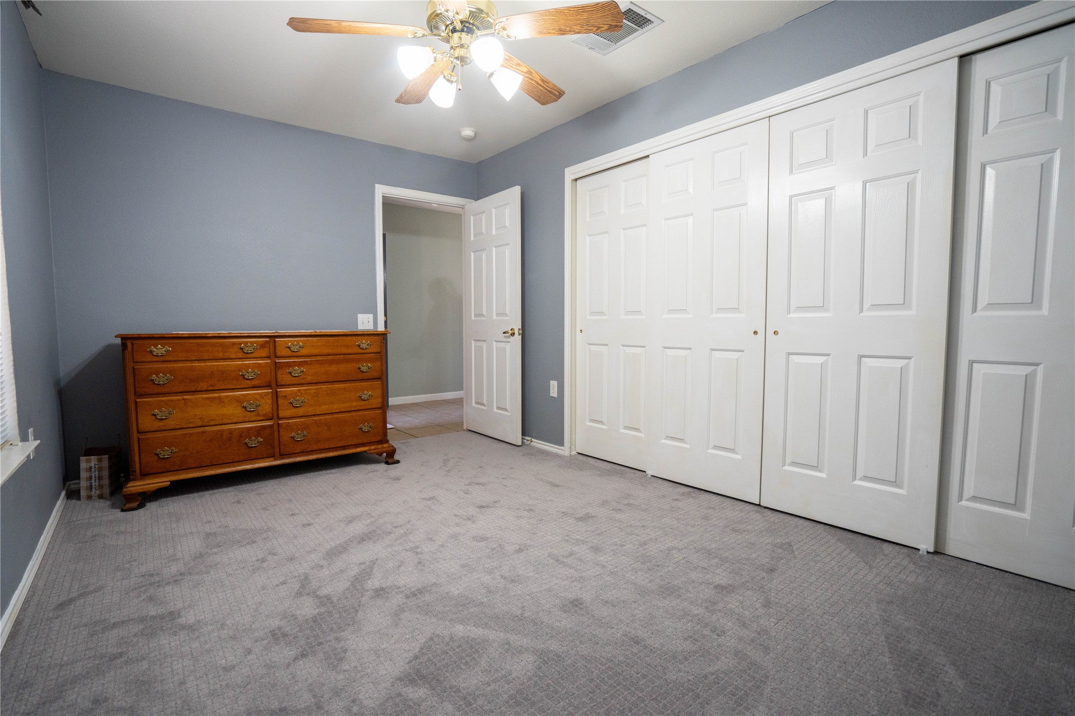 7516 Cats-Eye Lane Austin, TX 78747 - Photo 16 of 30 an empty room with windows and ceiling fan