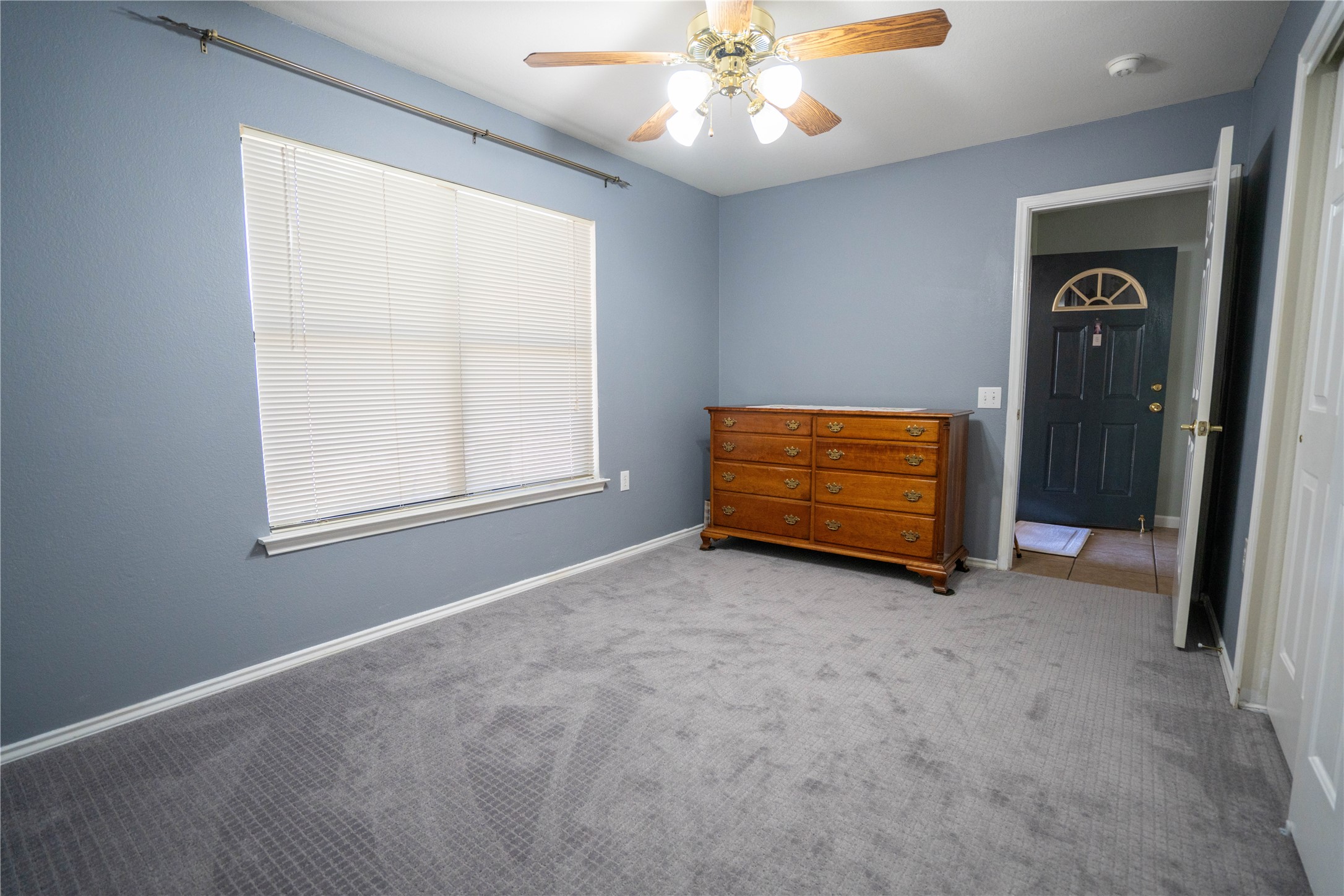 7516 Cats-Eye Lane Austin, TX 78747 - Photo 17 of 30 an empty room with windows and fan