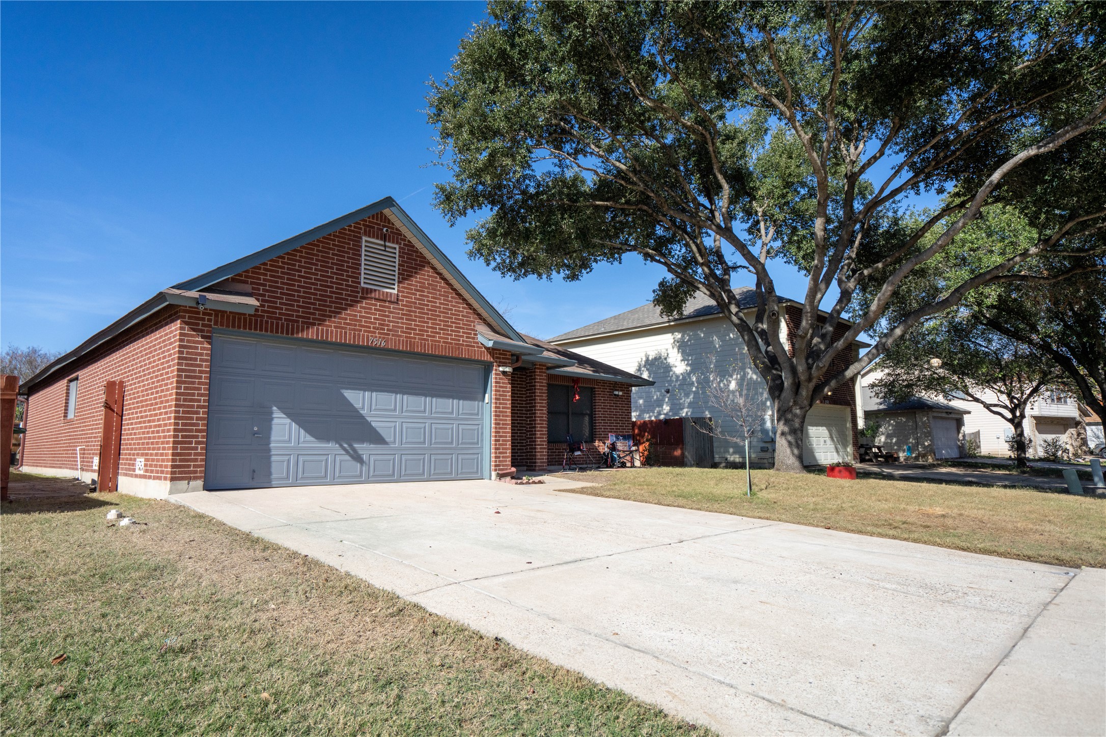 7516 Cats-Eye Lane Austin, TX 78747 - Photo 2 of 30 a front view of a house with a yard and garage